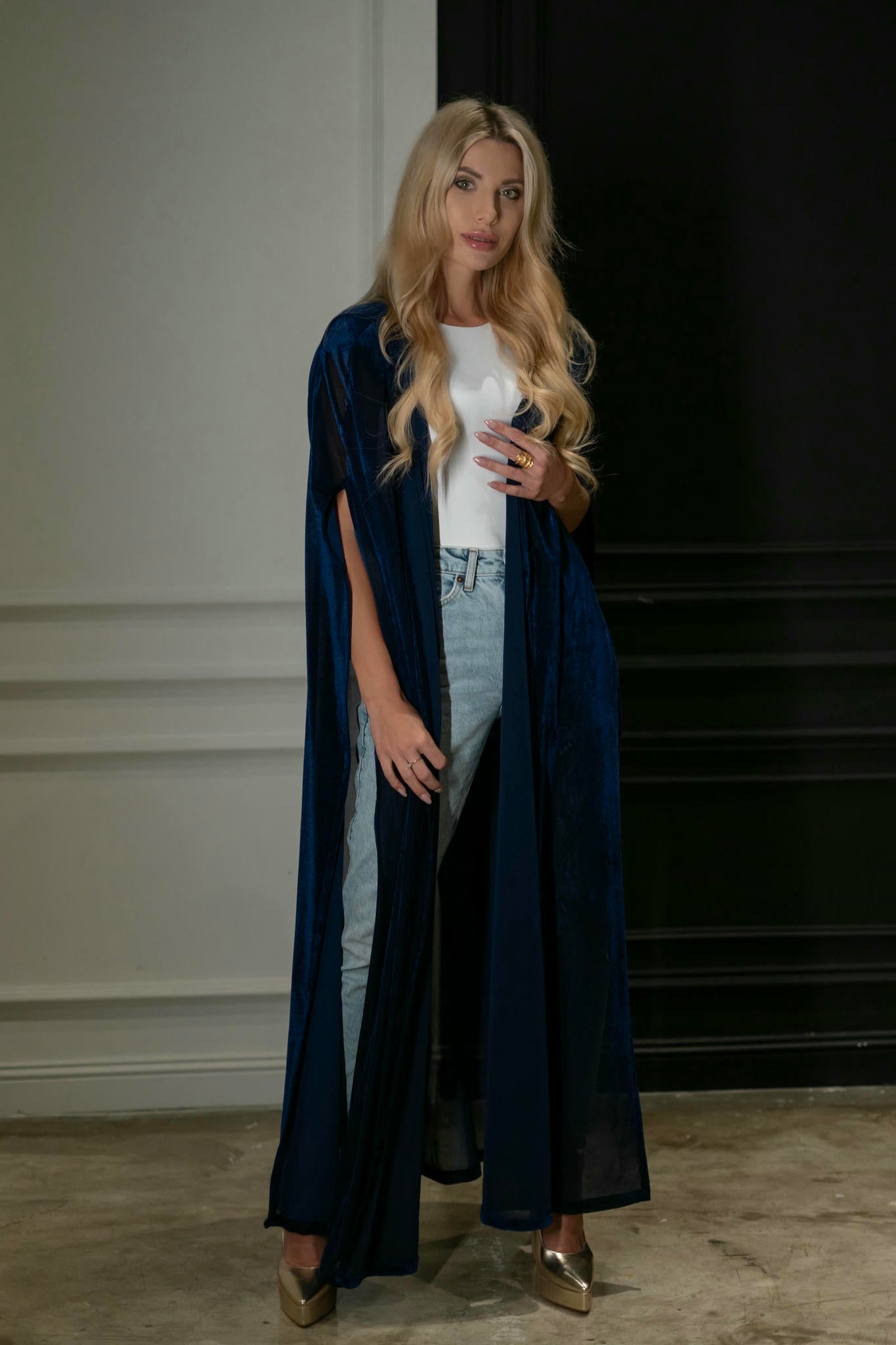 model wearing blue cape in casual style