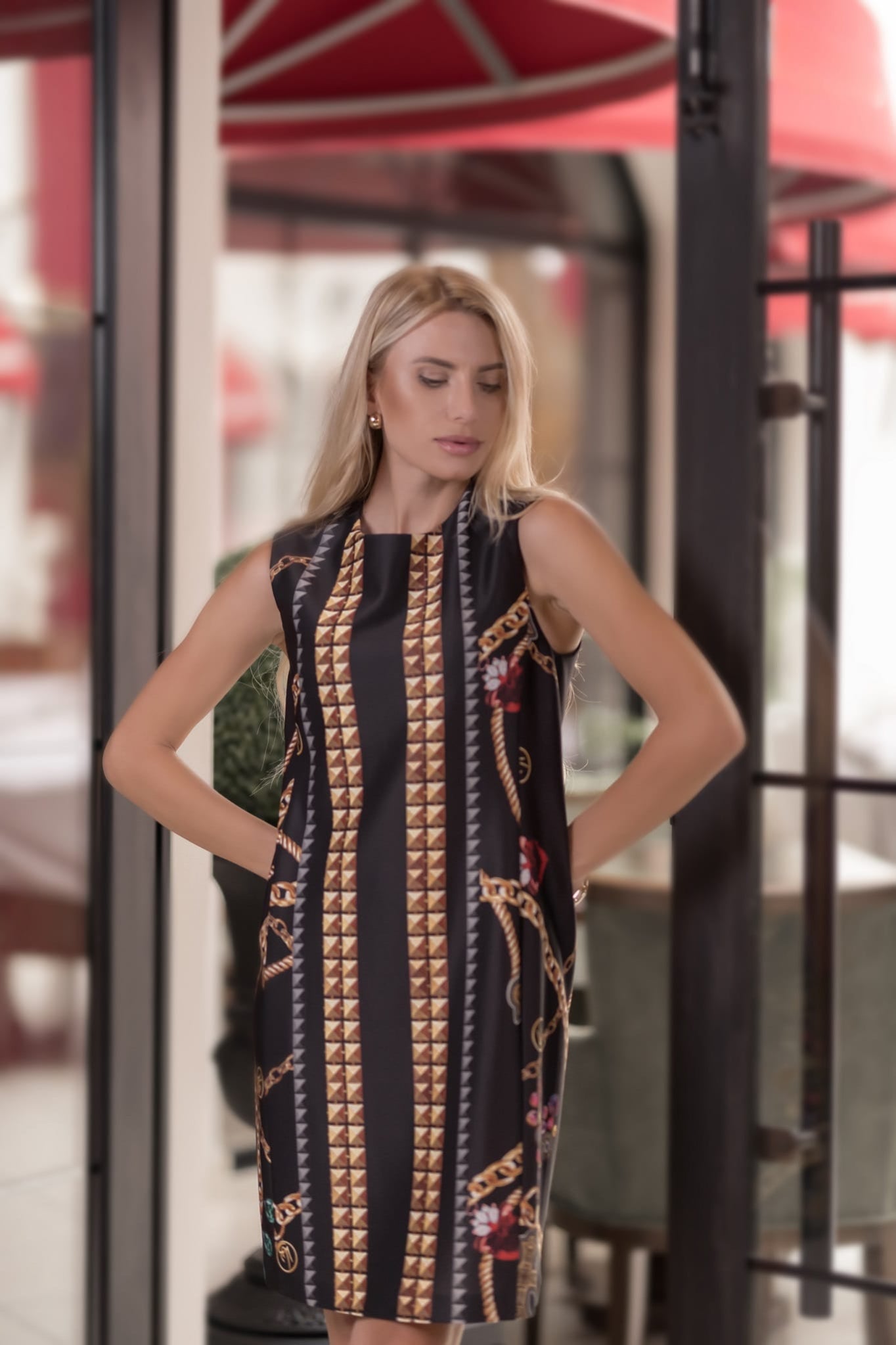 model wearing a patterned satin midi dress standing in an outdoor setting