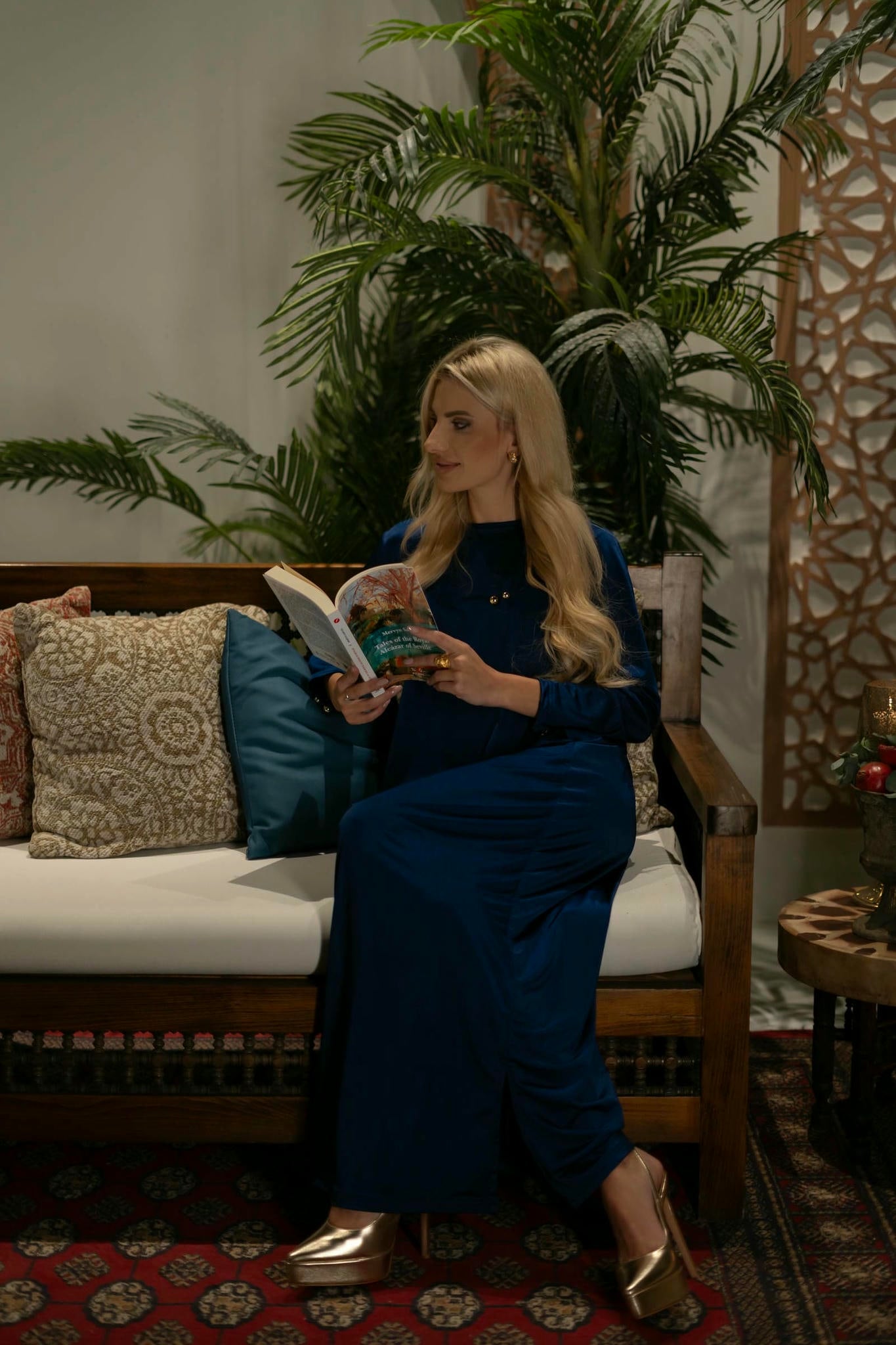 model wearing blue dress with cape in andalusian decor