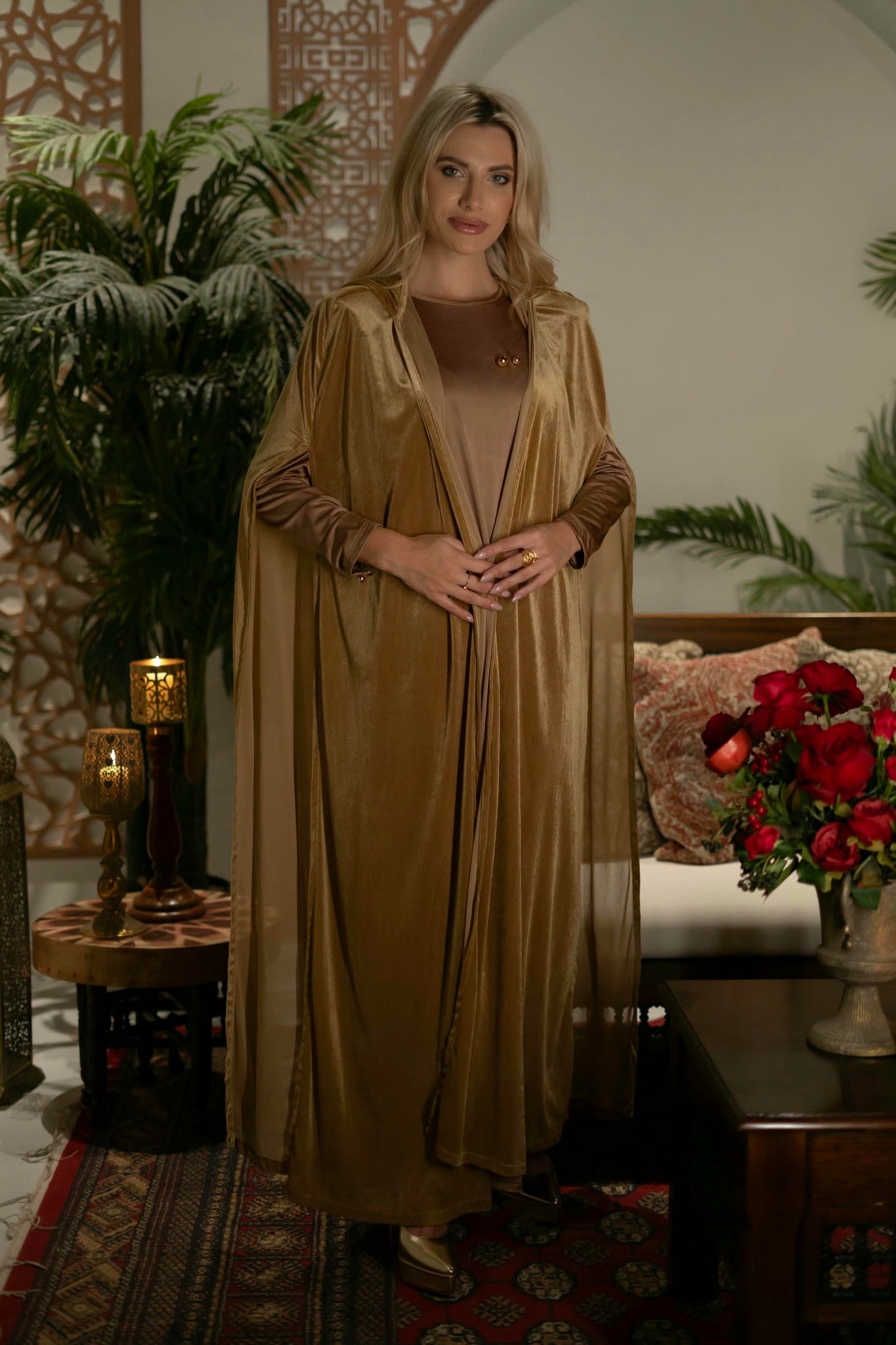 model wearing gold dress with cape in andalusian decor