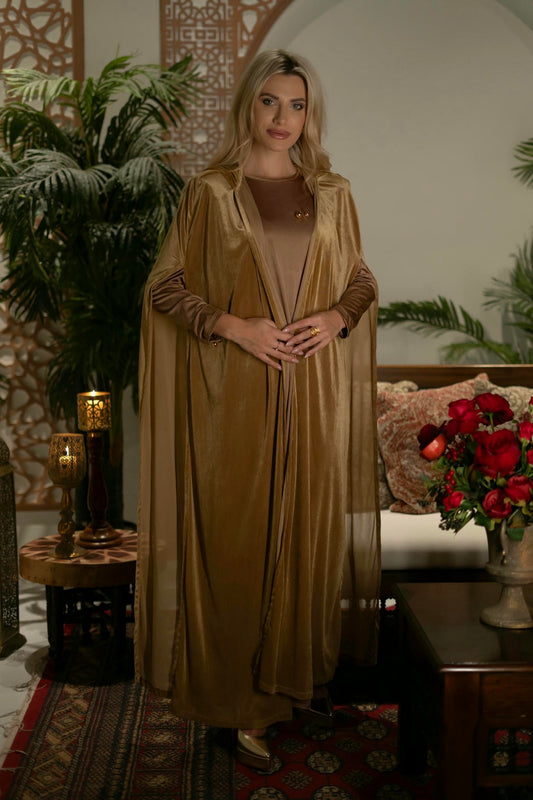model wearing gold dress with cape in andalusian decor