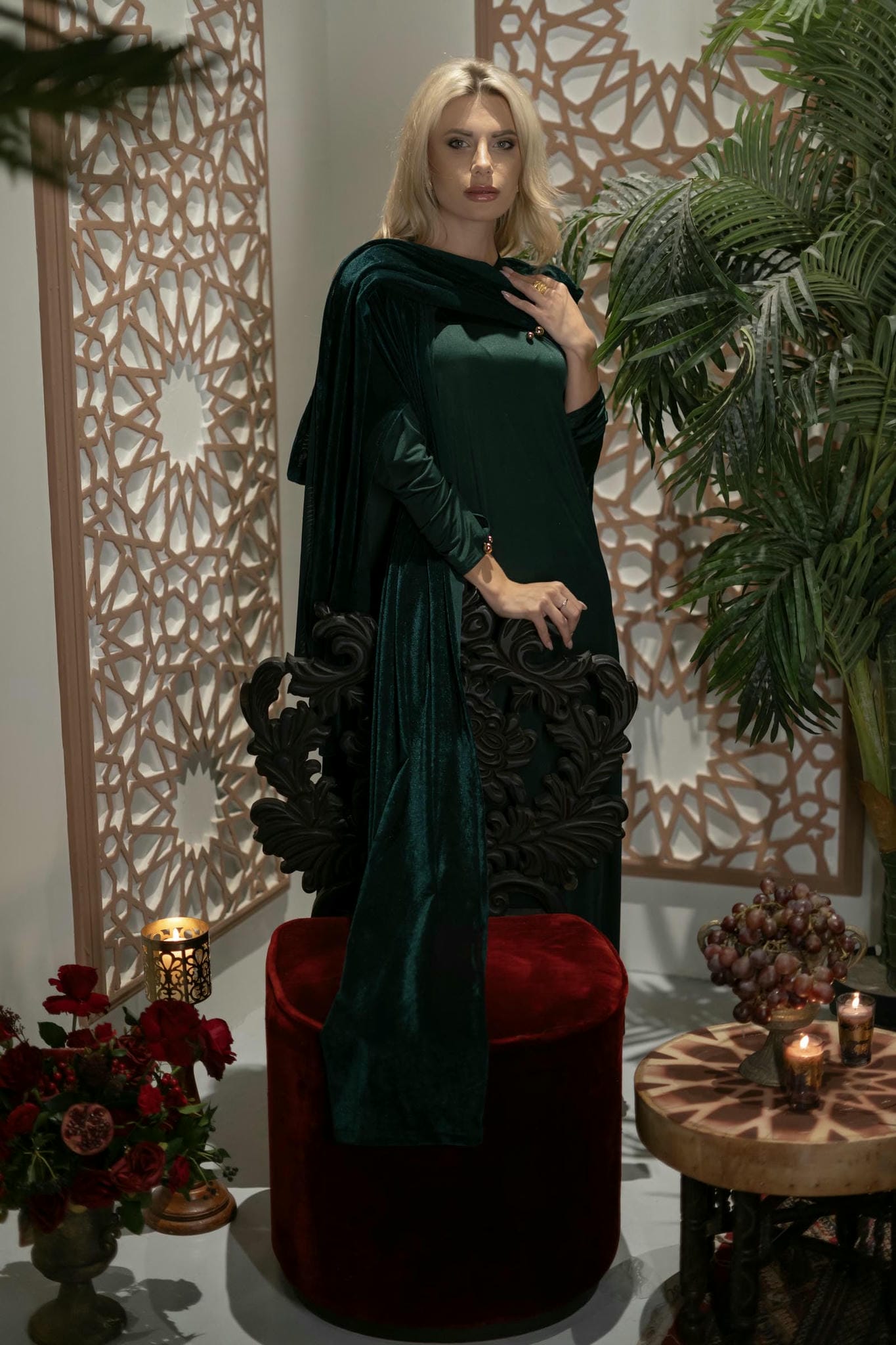 model wearing green dress with cape in Andalusian decor