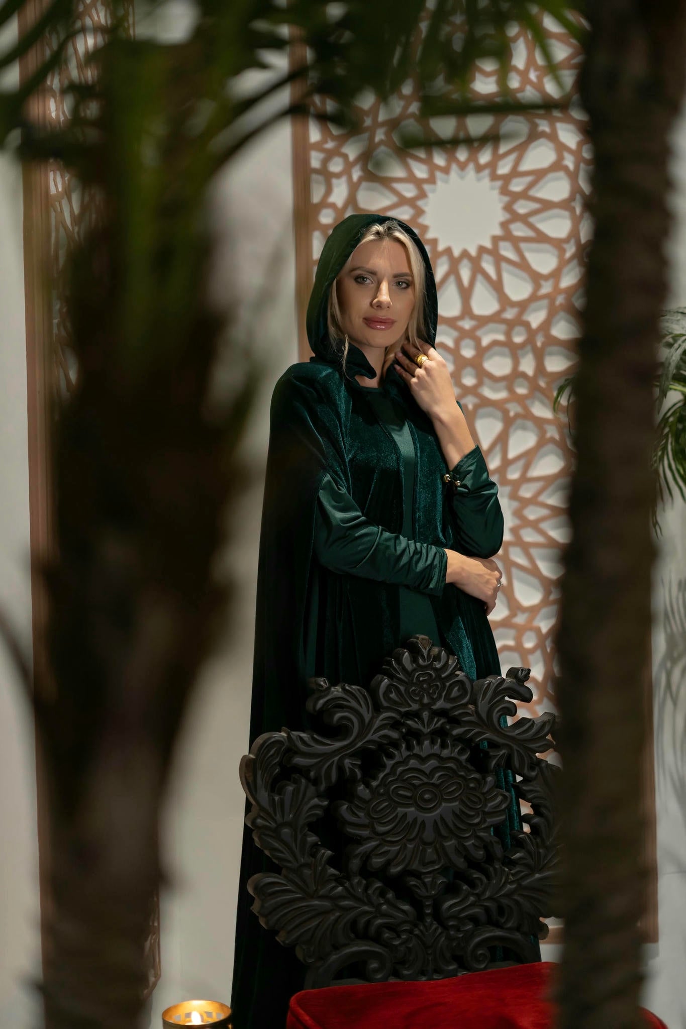 model wearing green dress with cape in Andalusian decor