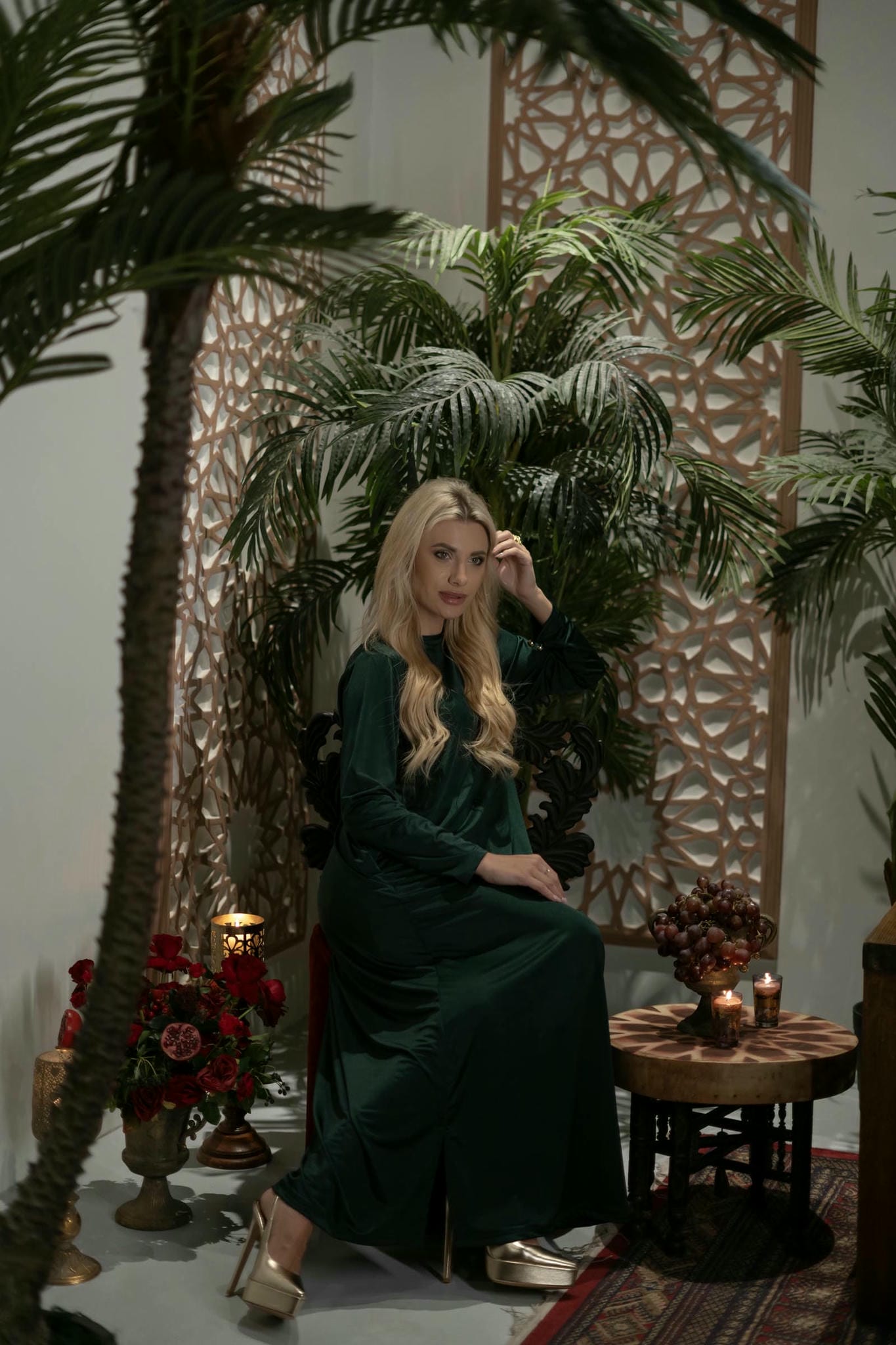 model wearing green dress with cape in Andalusian decor