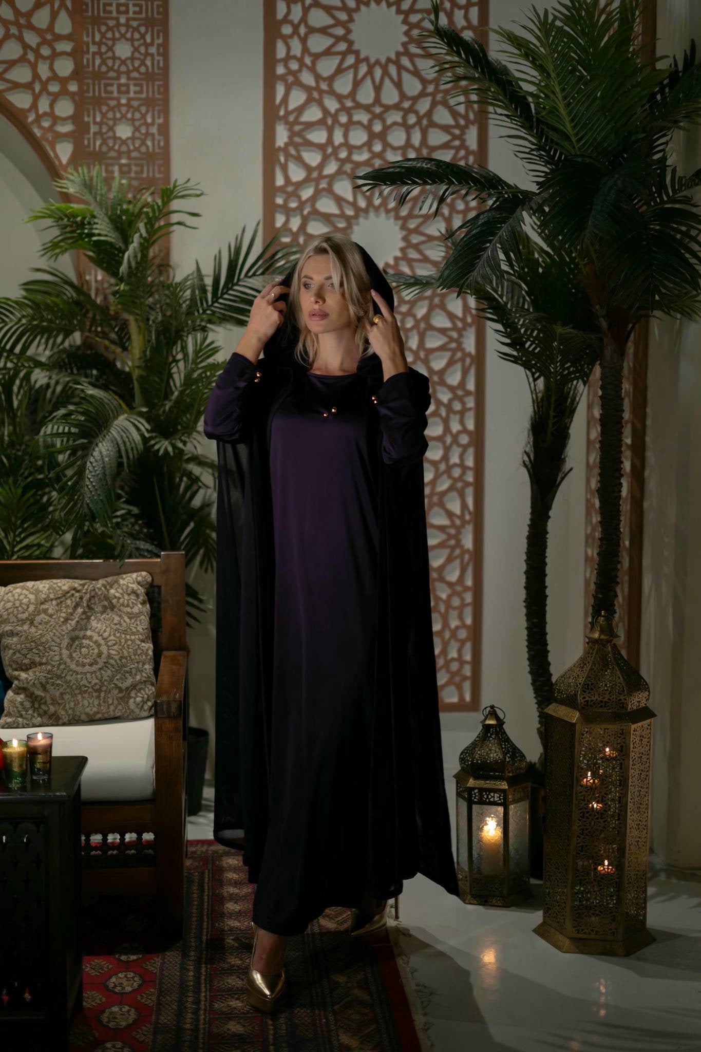 model wearing a purple dress with cape in andalusian decor