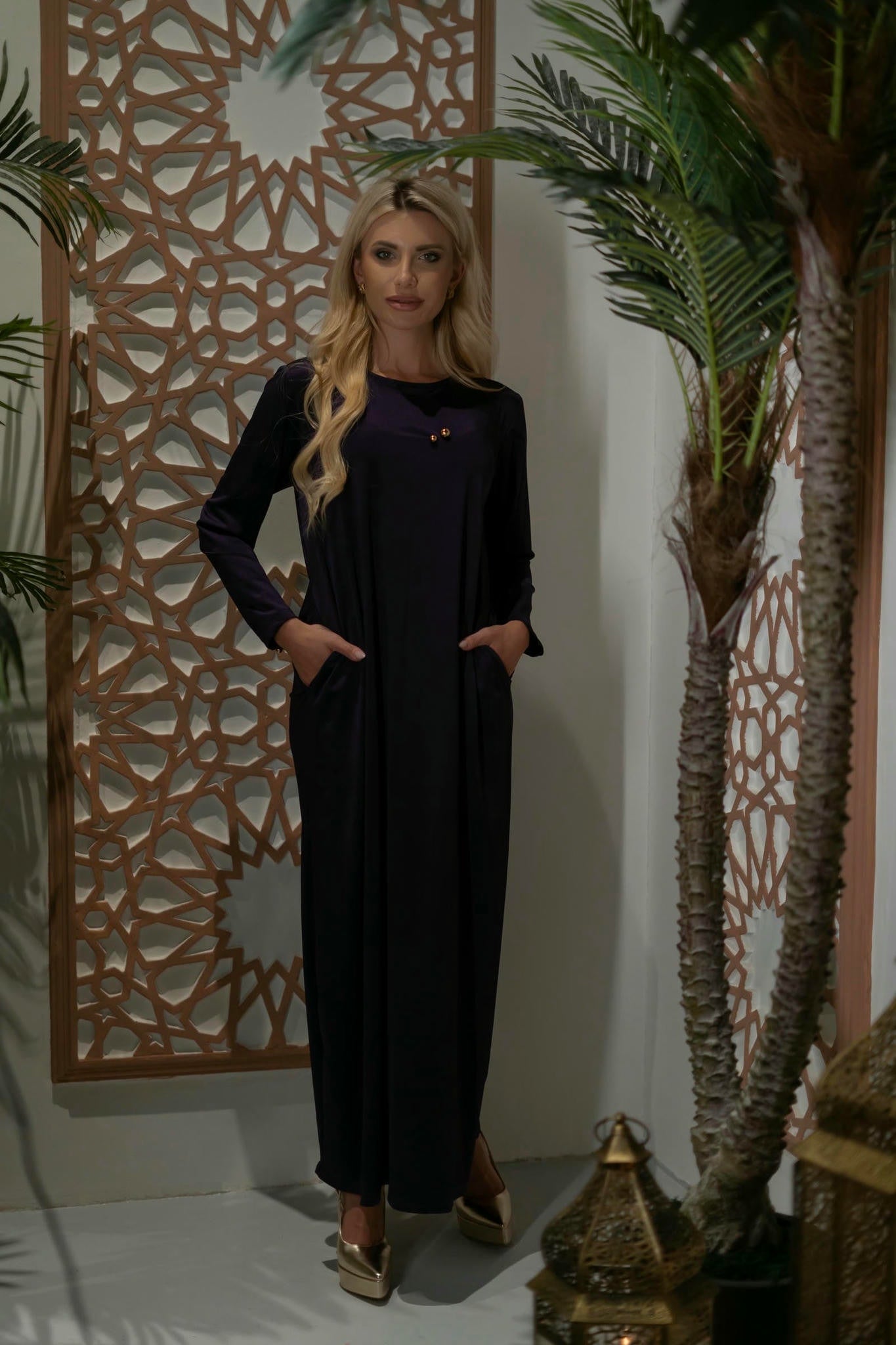 model wearing a purple dress with cape in andalusian decor