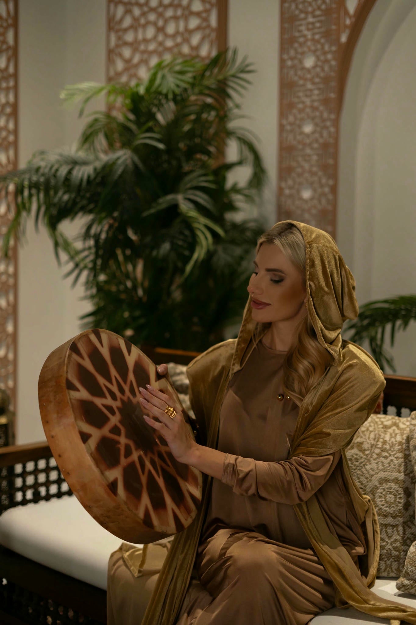 model wearing gold dress with cape in andalusian decor