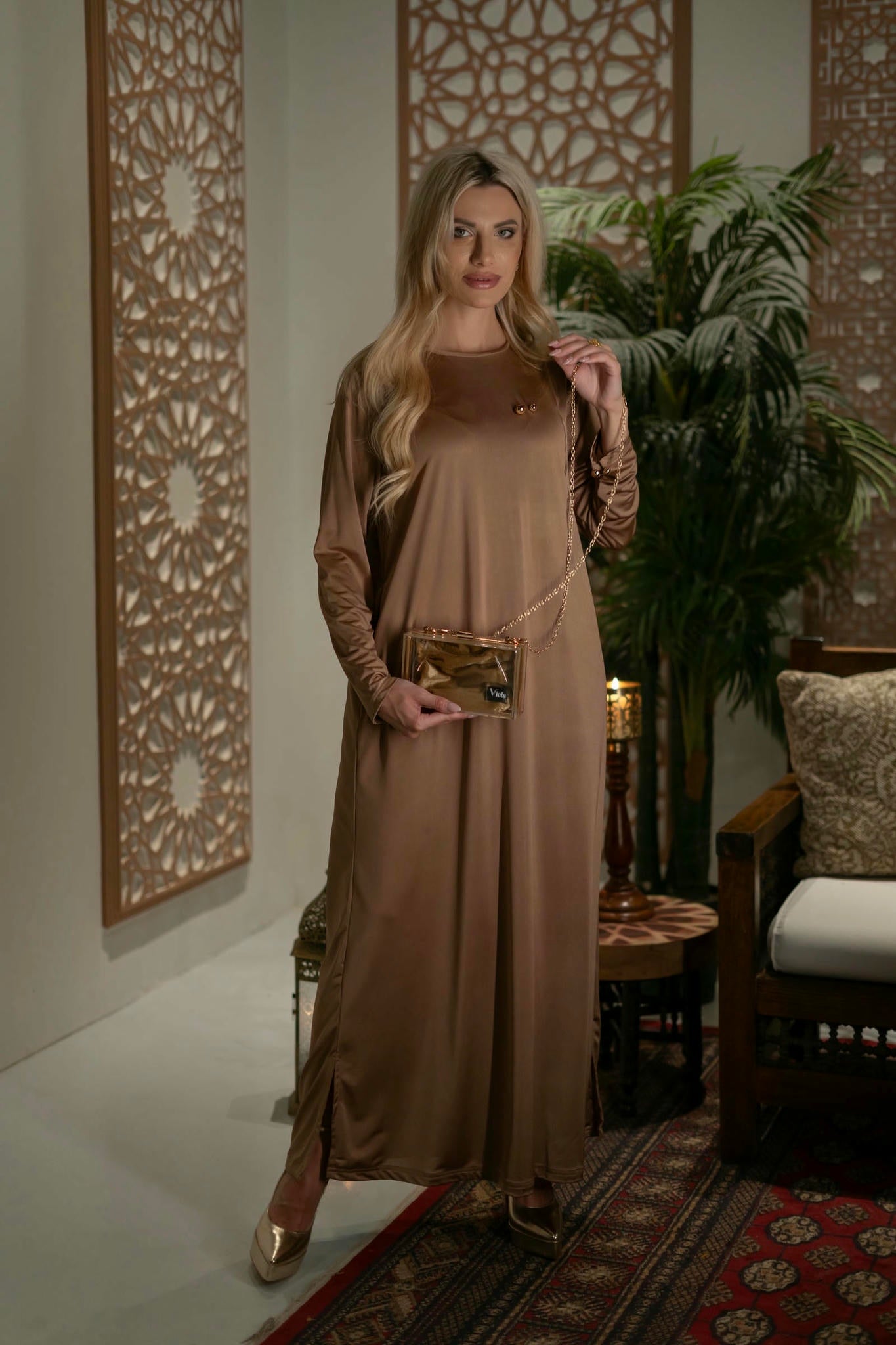 model wearing gold dress with cape in andalusian decor