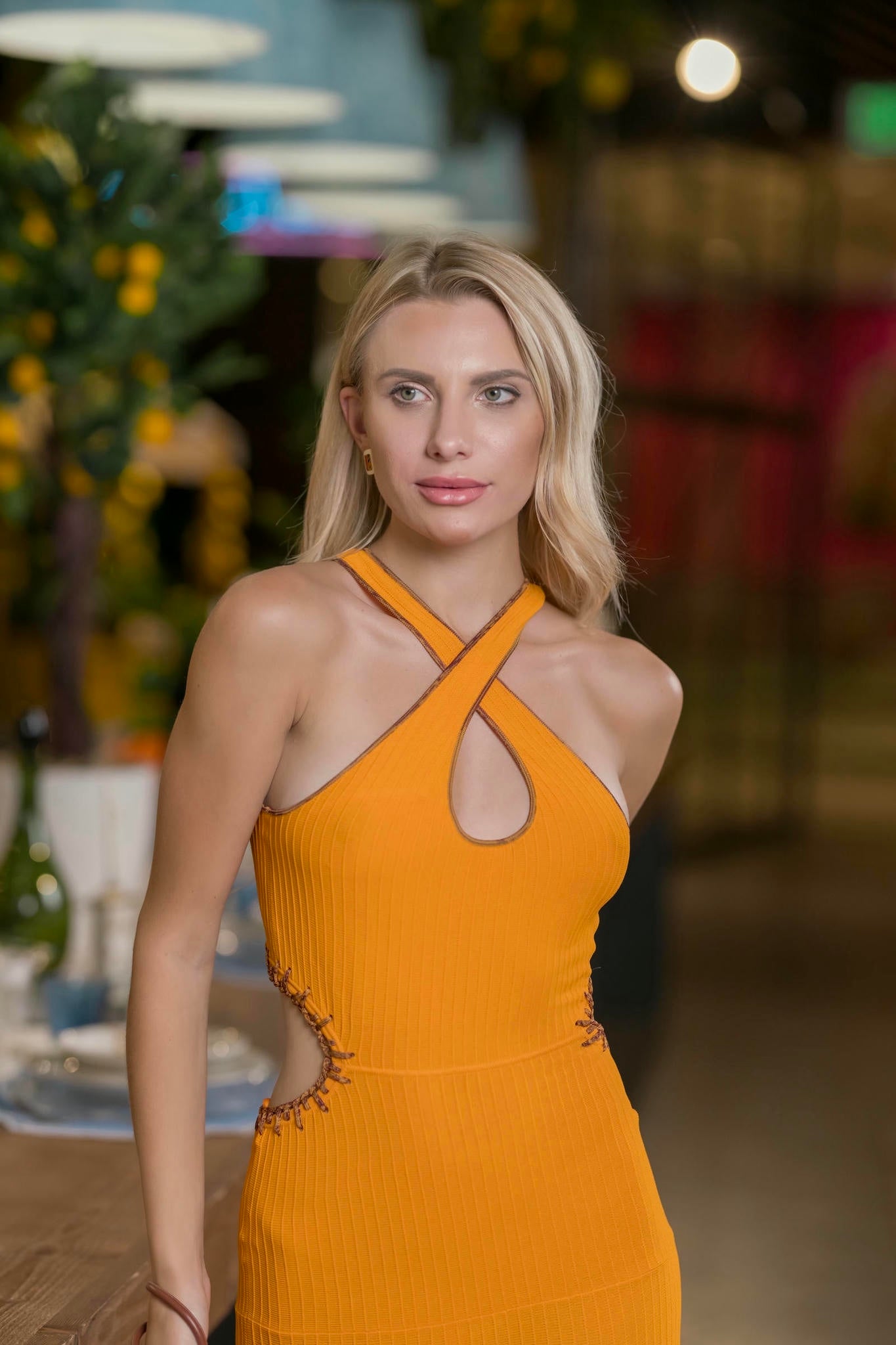 a model wearing an Orange Knit Maxi Gown