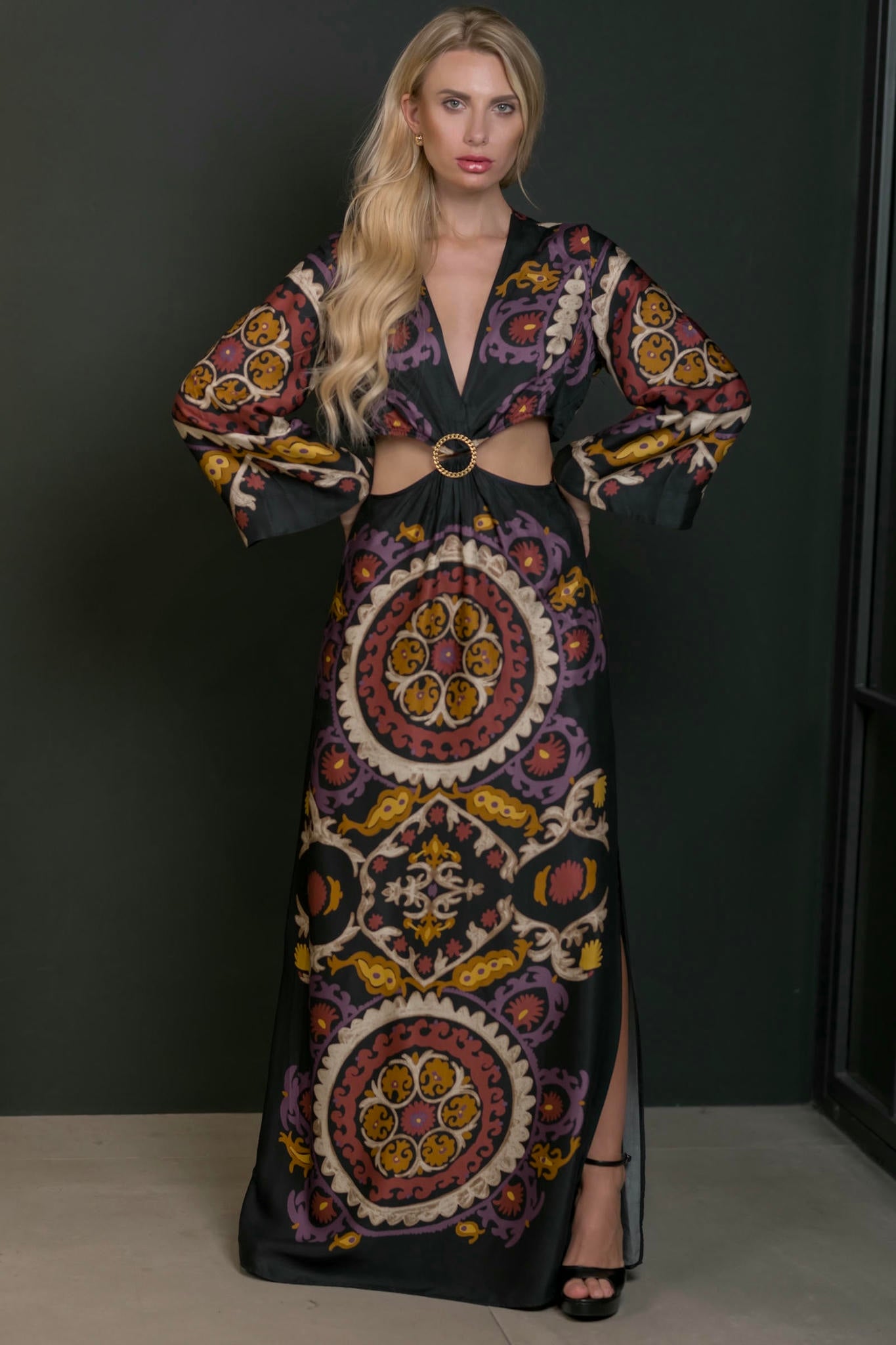 model wearing a maxi print dress with side slit and cut out waist