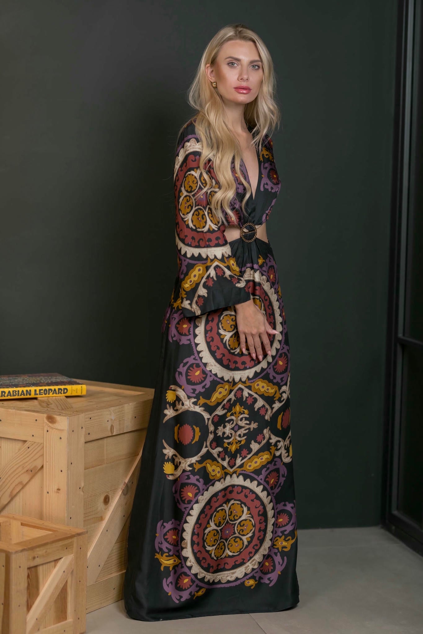 model wearing a maxi print dress with side slit and cut out waist