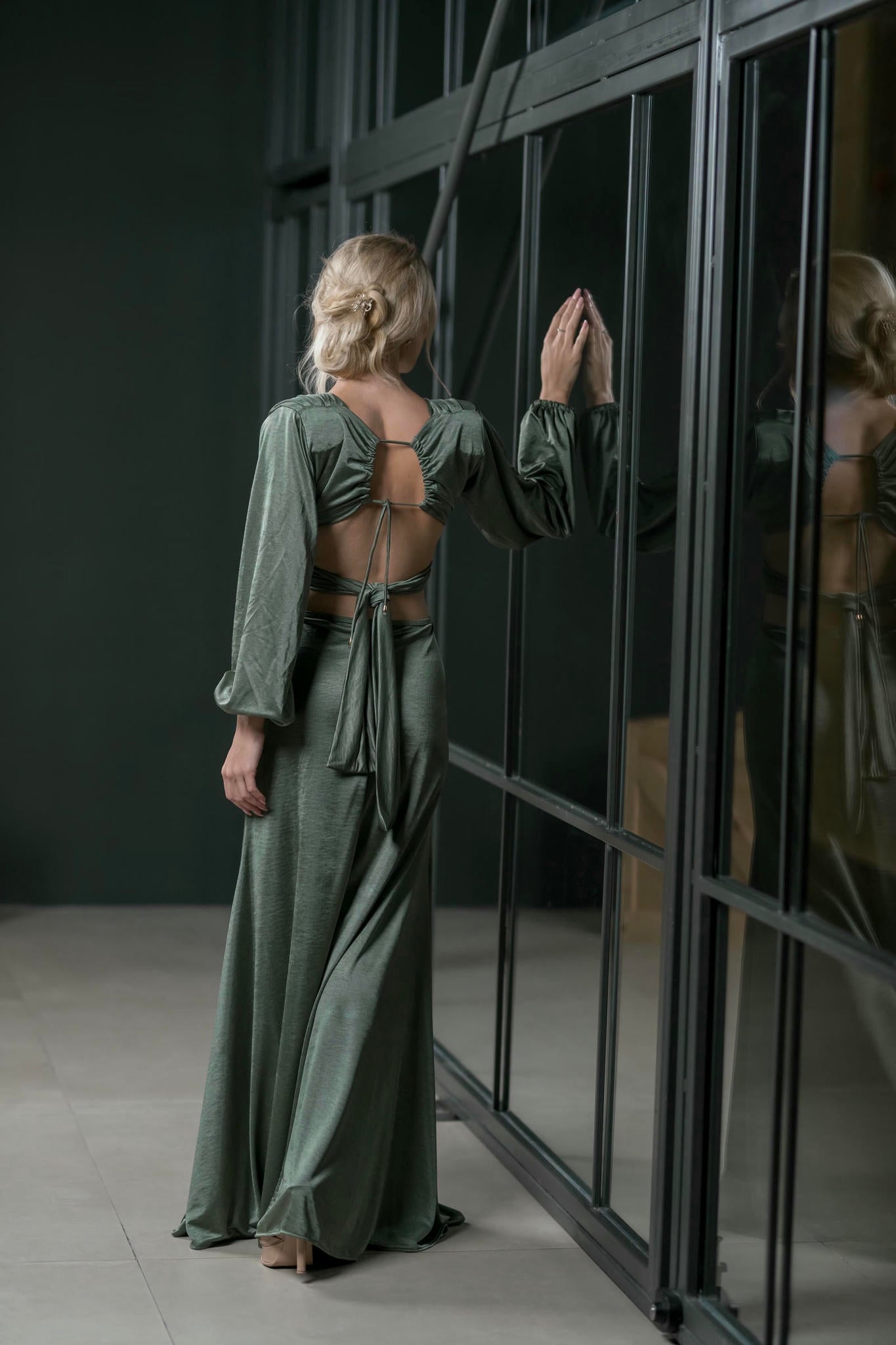 a model wearing an Emerald Green Maxi Satin Gown