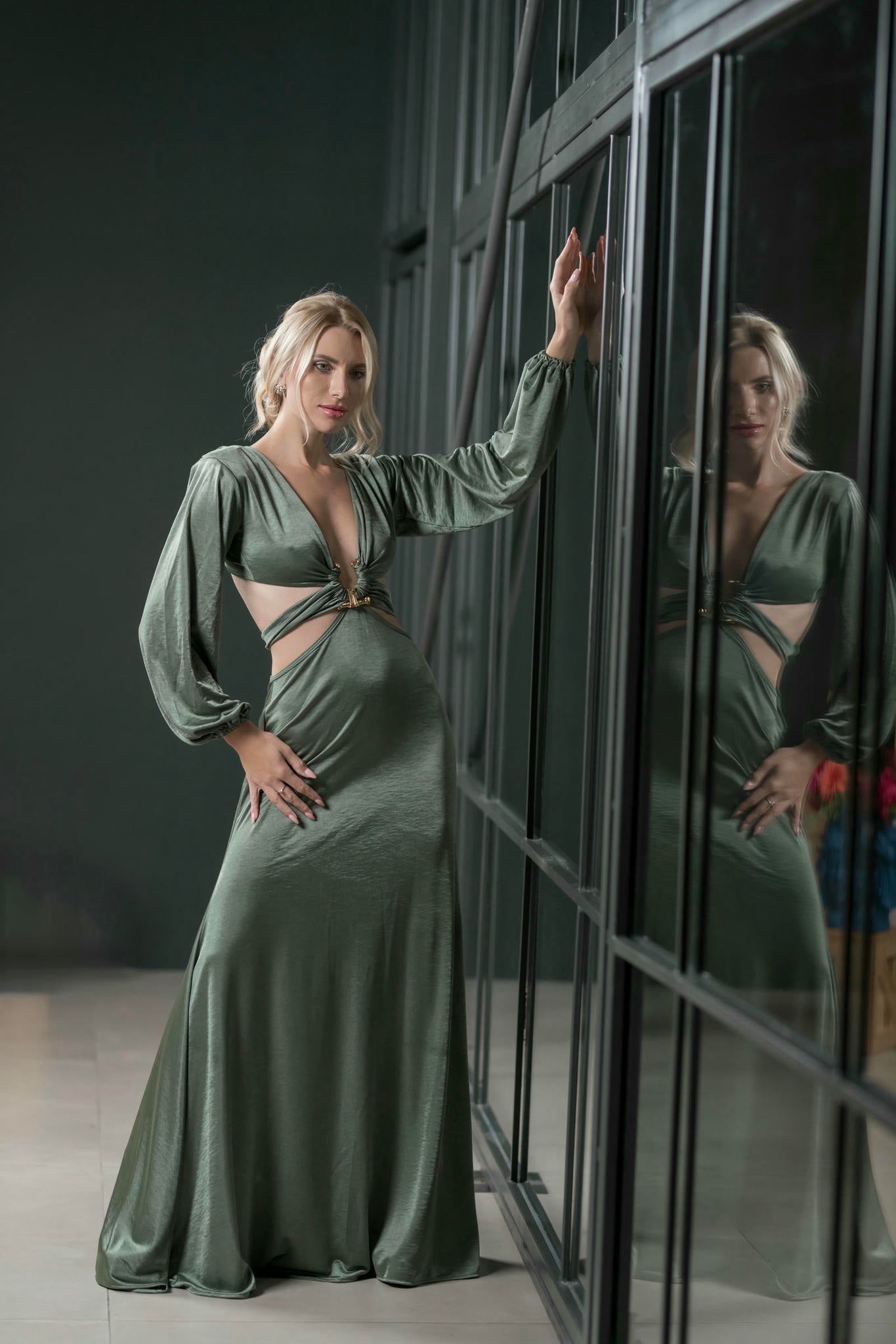 a model wearing an Emerald Green Maxi Satin Gown