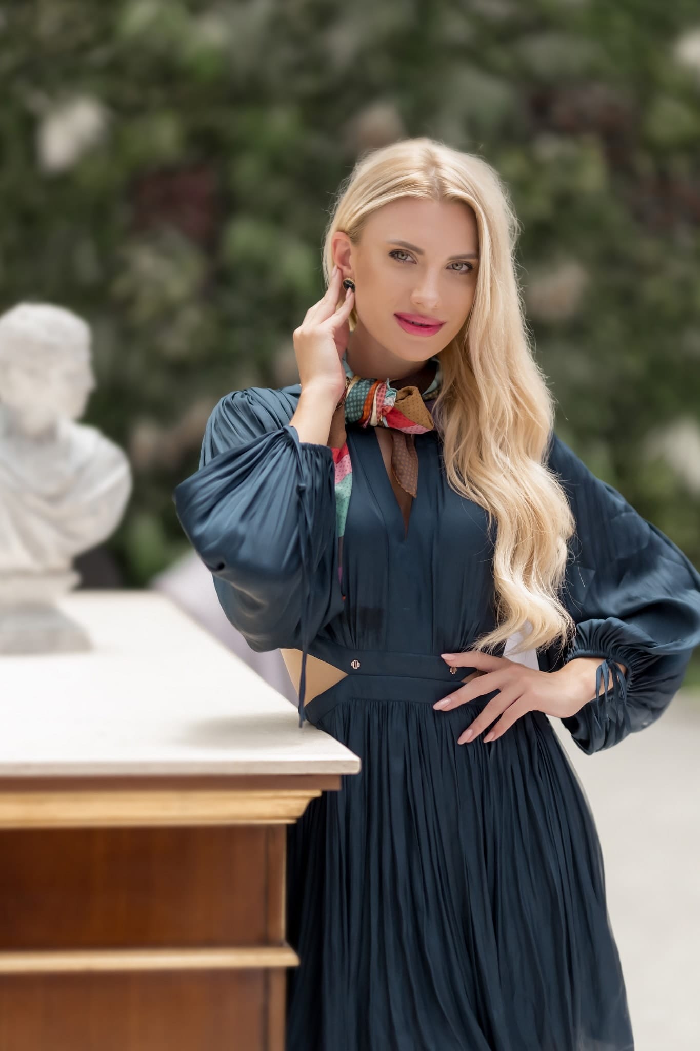 model wearing a blue satin midi dress