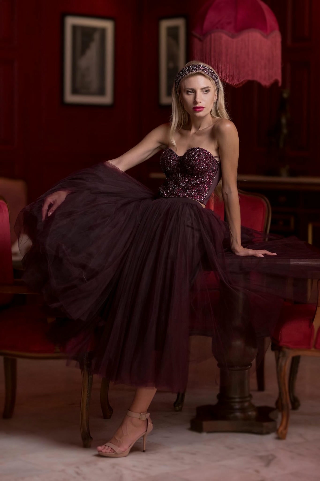 a model wearing a Plum Tulle Skirt and Corset Set with Velvet Fur Cape