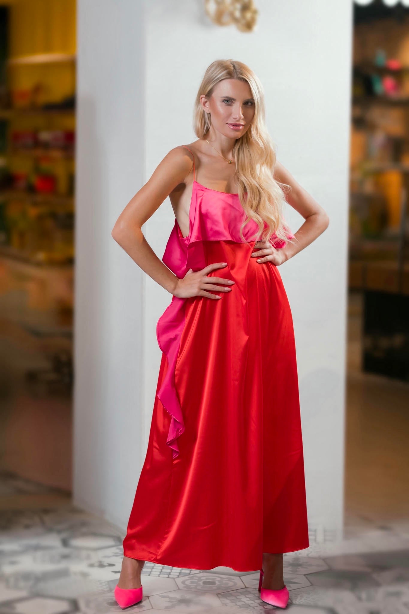 model wearing a Fuchsia and Coral Silk Gown with Ruffled Bodice
