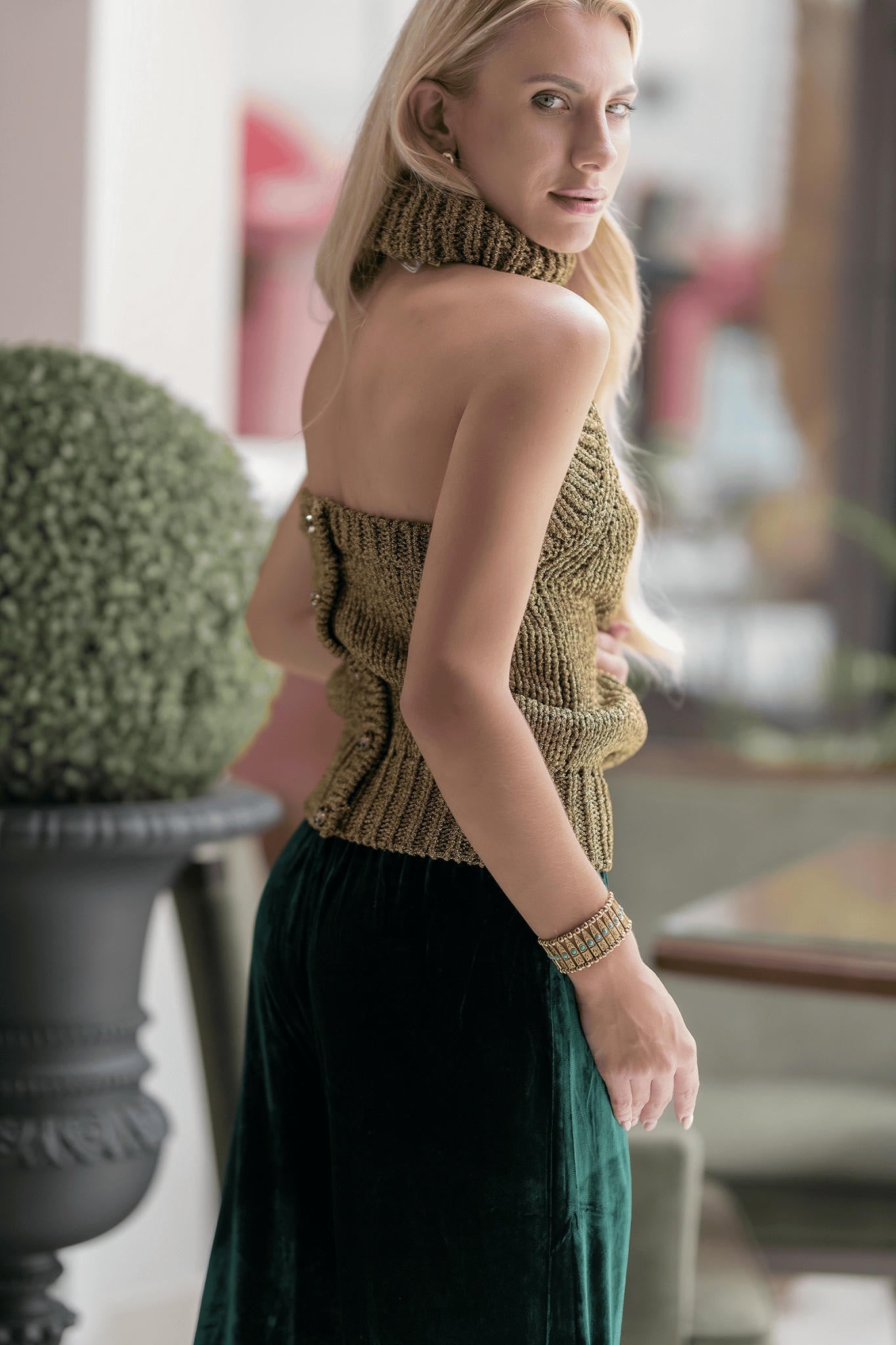 a model wearing a Gold Top and Emerald Velvet Trousers