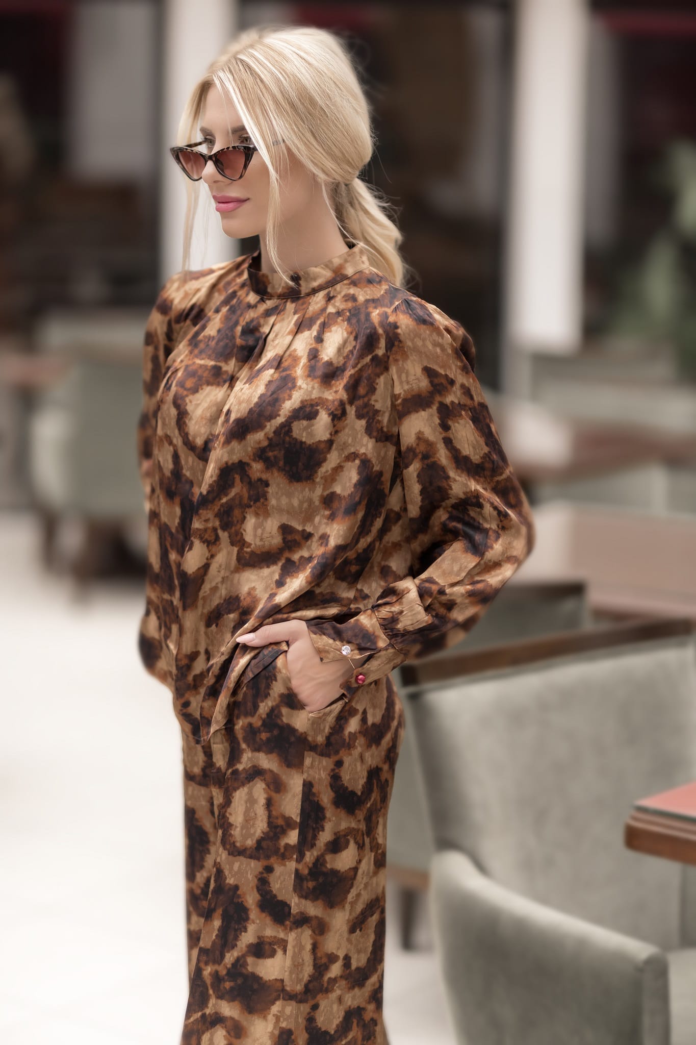 Woman wearing a leopard print outfit in an indoor setting