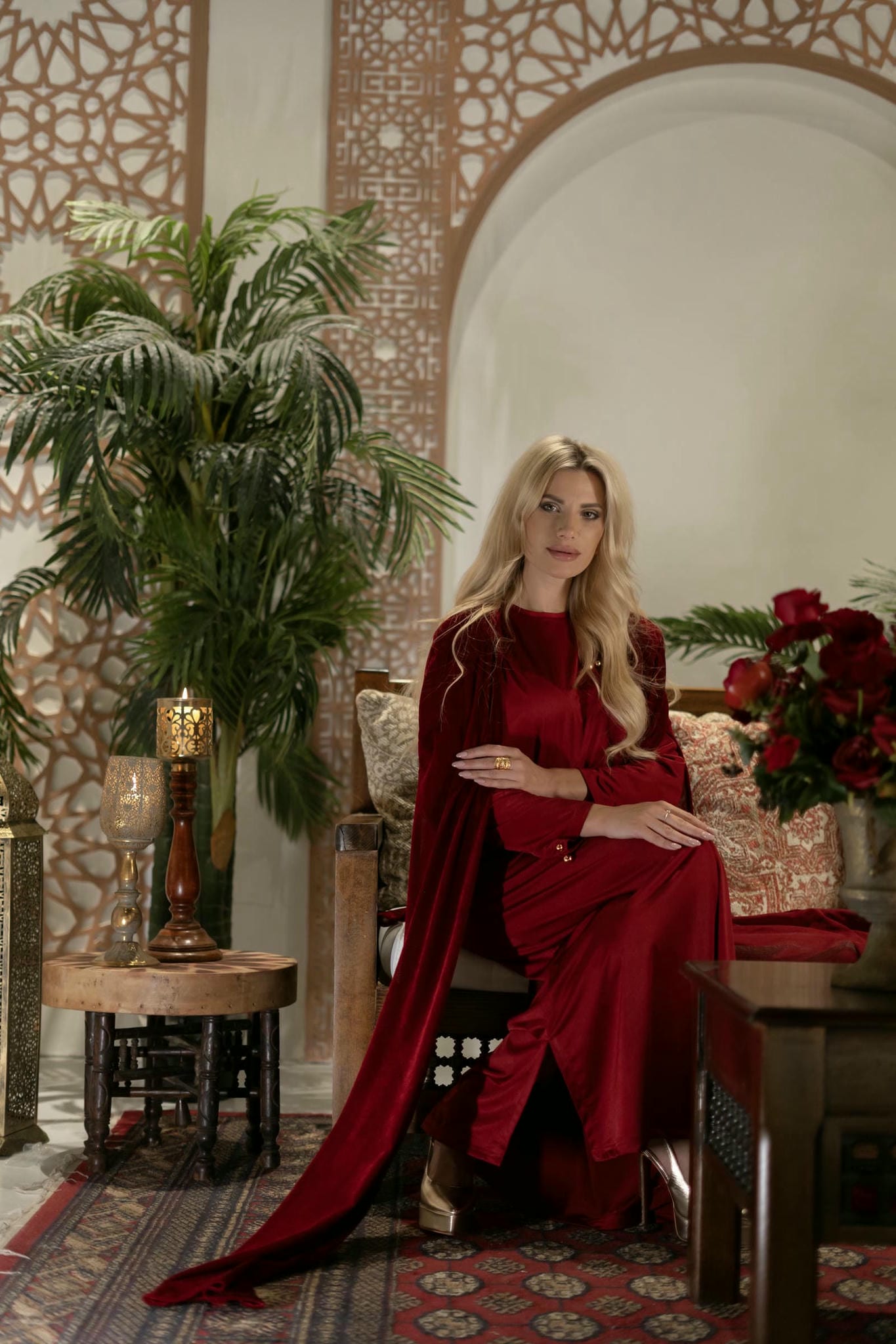 model wearing red modest dress with cape in andalusian scene