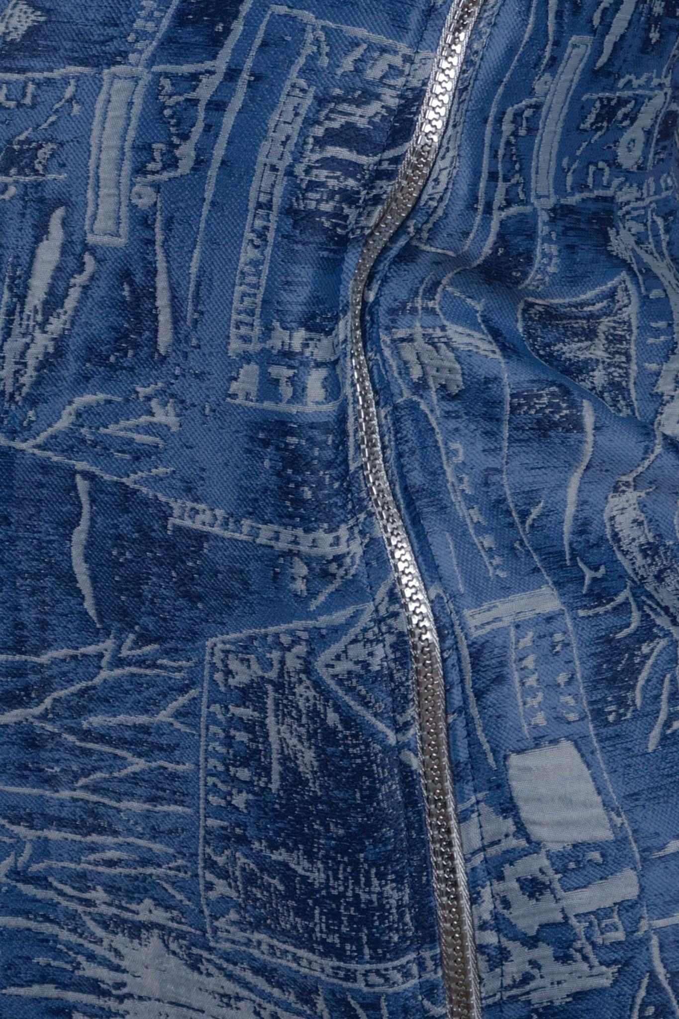 Close-up of a blue textured fabric with a zipper