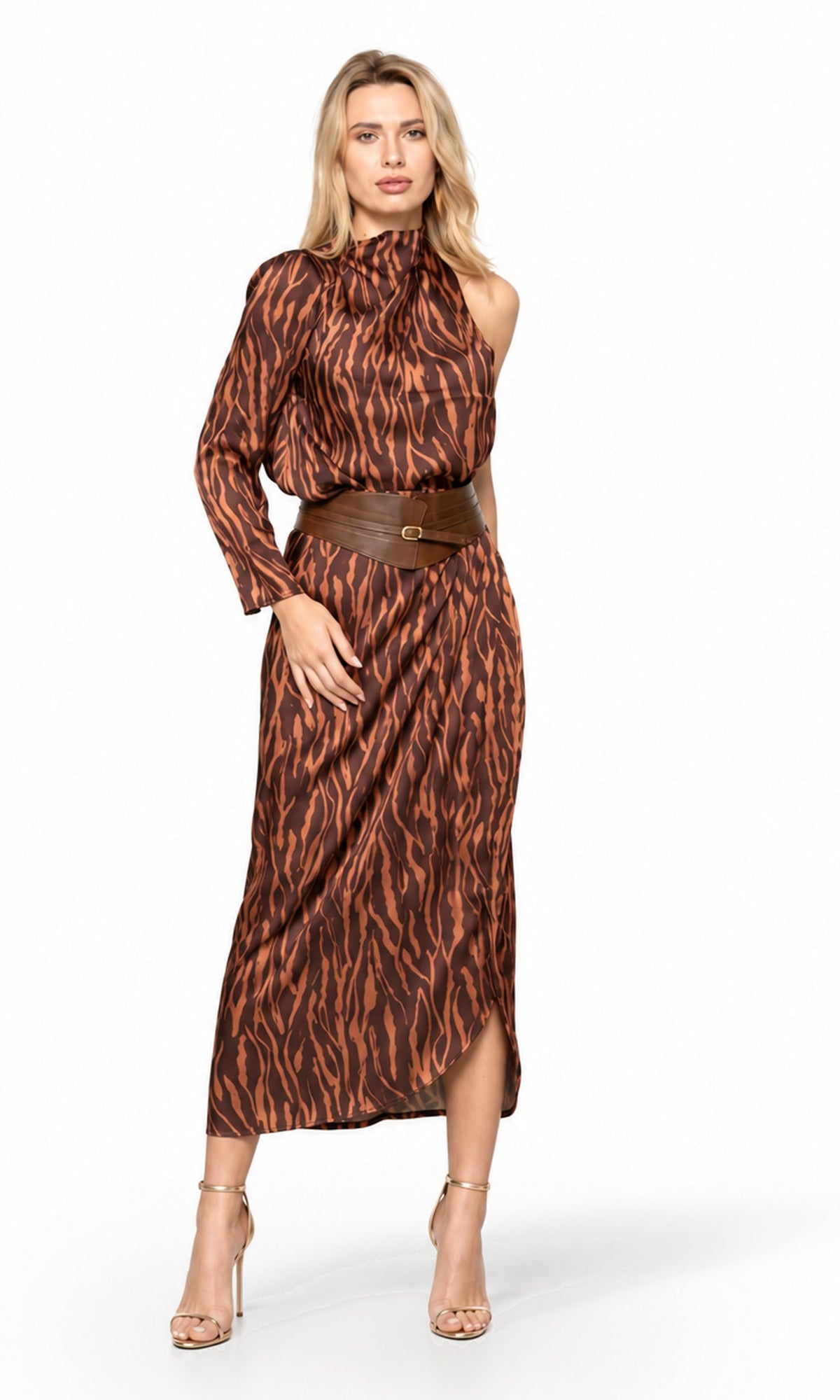 A woman modeling a brown and black tiger-stripe print midi dress with a halter neckline, long sleeves, and a matching brown belt, set against a plain white studio background.