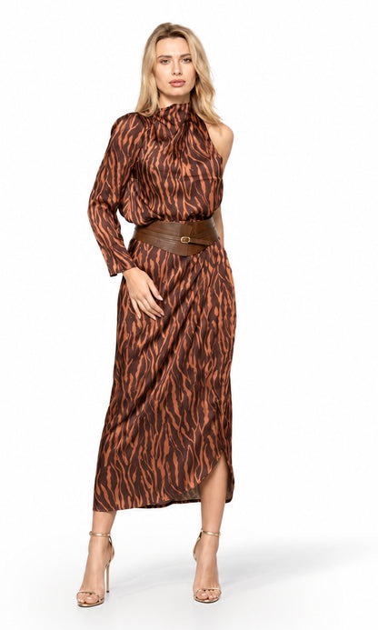 A woman modeling a brown and black tiger-stripe print midi dress with a halter neckline, long sleeves, and a matching brown belt, set against a plain white studio background.