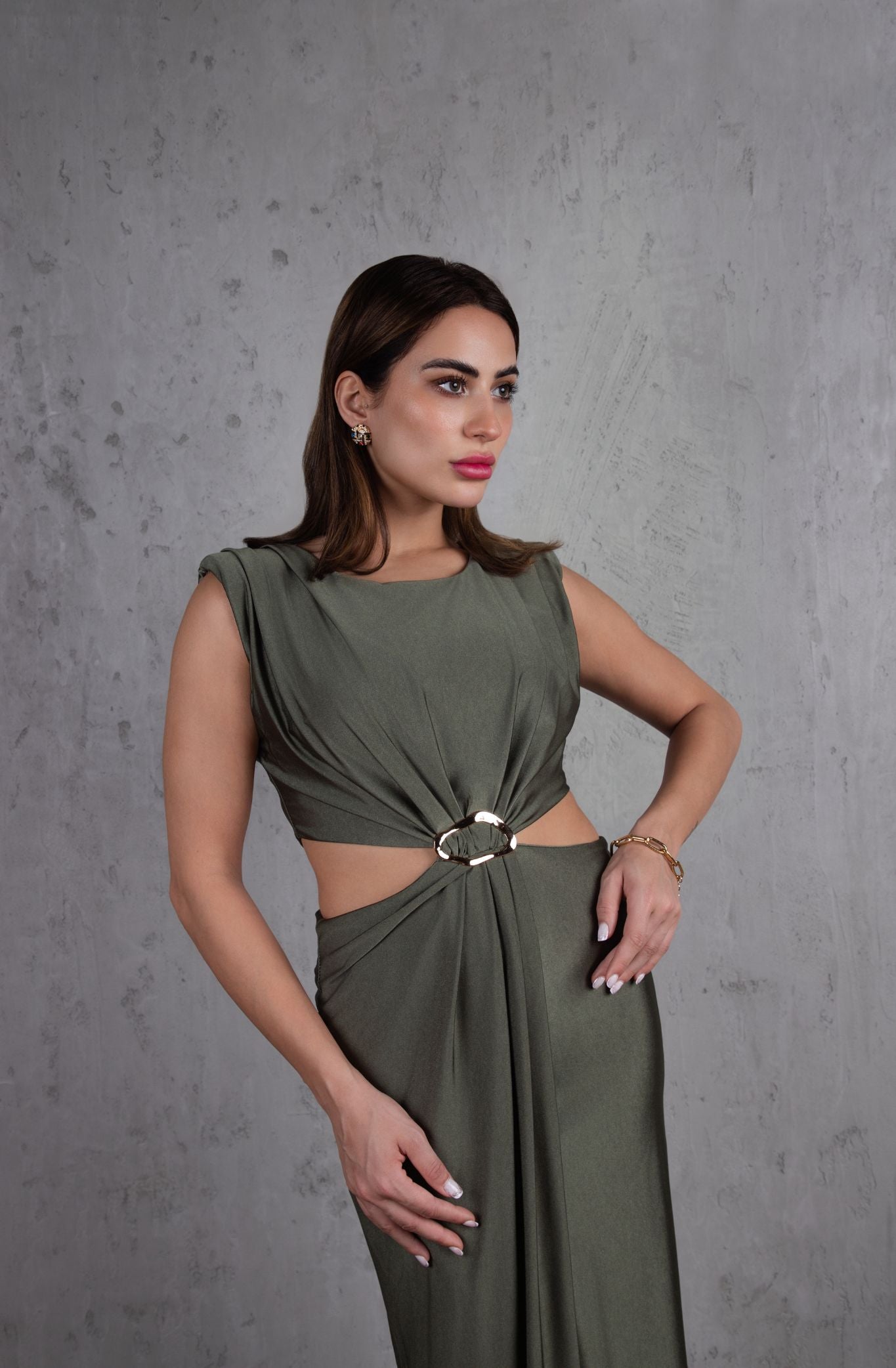 Woman wearing a green dress against a gray background