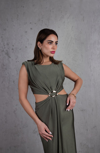 Woman wearing a green dress against a gray background