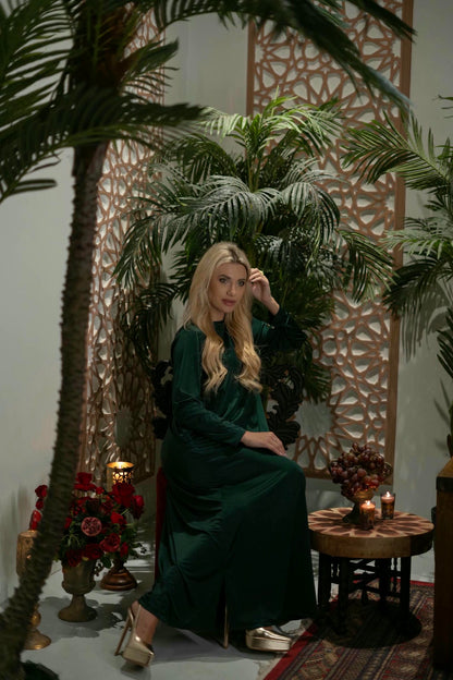 model wearing green dress with cape in Andalusian decor