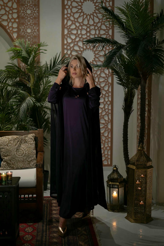 model wearing a purple dress with cape in andalusian decor