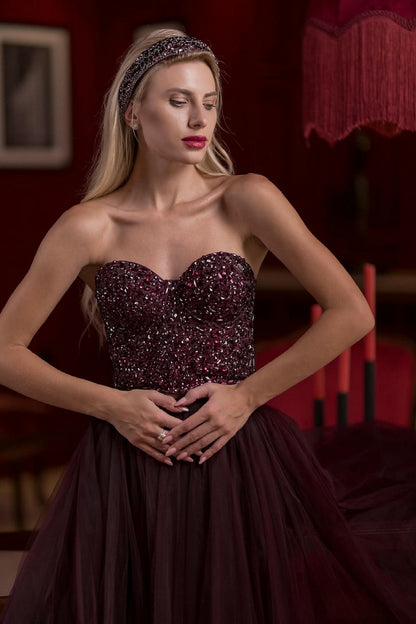 a model wearing a Plum Tulle Skirt and Corset Set with Velvet Fur Cape