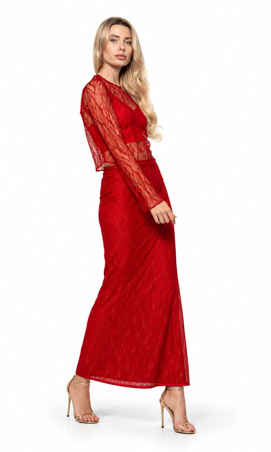 A woman modeling a red lace maxi dress with sheer long sleeves and a fitted waist, paired with nude high-heeled sandals, against a plain white studio background.