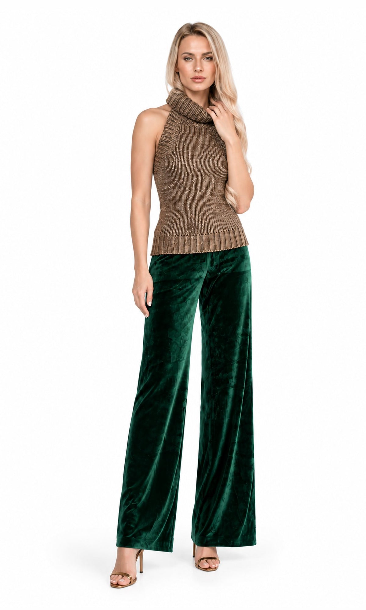 A woman modeling a sleeveless brown knit mock-neck top paired with dark green velvet wide-leg pants, standing against a plain white background.